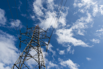 High voltage pole, clouds, blue sky