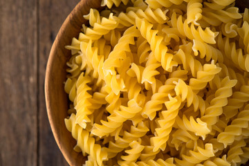 raw pasta in wood plate on wood background

