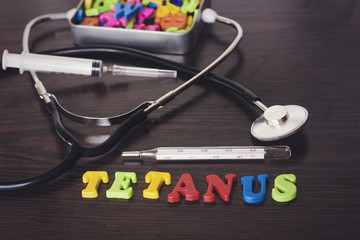 colorful letter tetanus and thermometer,stethoscope,syringe,metal box of letters