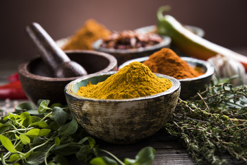 Spices and herbs in wooden bowls. Food and cuisine ingredients
