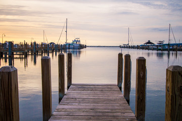 Boater Summer Sunset Over Lake Michigan Harbor.  Wooden dock with a marina and scenic sunset colors...