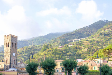 Naklejka premium Daylight view to Monterosso al Mare mountains, townbell and a pa