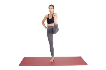 young asian woman doing yoga in Hasta Padangusthasana or Standing Hand to Toe yoga pose on the mat isolated on white background, exercise fitness, sport training and healthy lifestyle concept