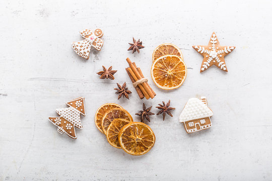 Cinnamon star anise gingerbread and dry orange on white concrete background. Top of view