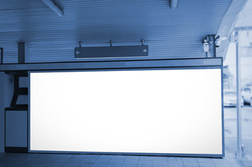 blank advertising billboard or light box at subway train station, blue color tone, copy space for your text message or media content, commercial and marketing concept