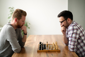 Portrait of two young man playing chess