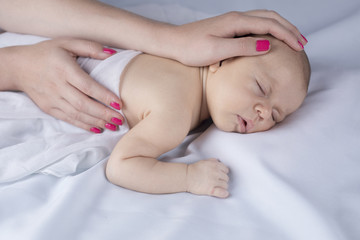 Newborn baby hand holding mother