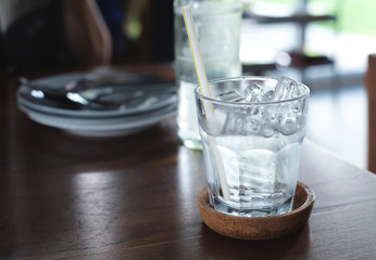 iced water in glass put on wooden table