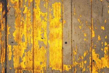 Yellow weather worn wooden texture with paint peeling off