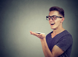 speech recognition concept. hands free communication. Young man using smart phone