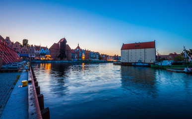 Fototapeta premium Gdansk at night with reflection in Motlawa river, Poland