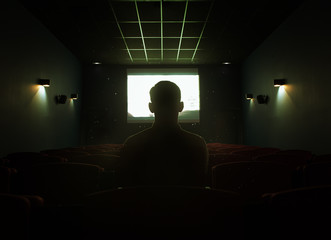 One man sitting in empty cinema hall
