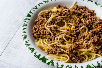 Spaghetti with Minced Meat on white wooden surface.