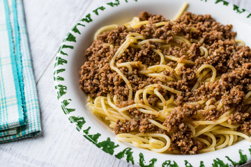 Spaghetti with Minced Meat on white wooden surface.