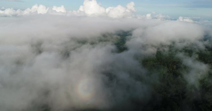 Aerial View. Flying over the beautiful mountain in clouds.
