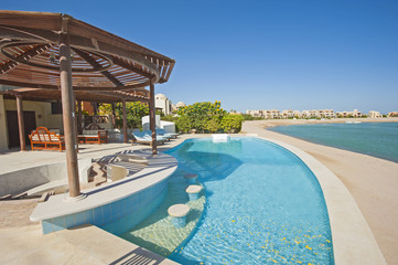 Swimming pool at at luxury tropical holiday villa resort
