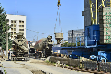 A container of liquid concrete rises to a height of a crane at a construction site in Mogilev,...