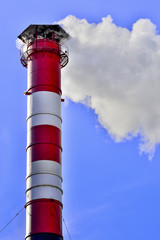 industrial smoke from chimney on blue sky