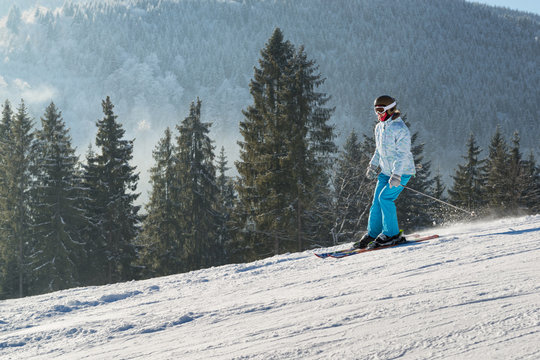 Young female skier on a slope