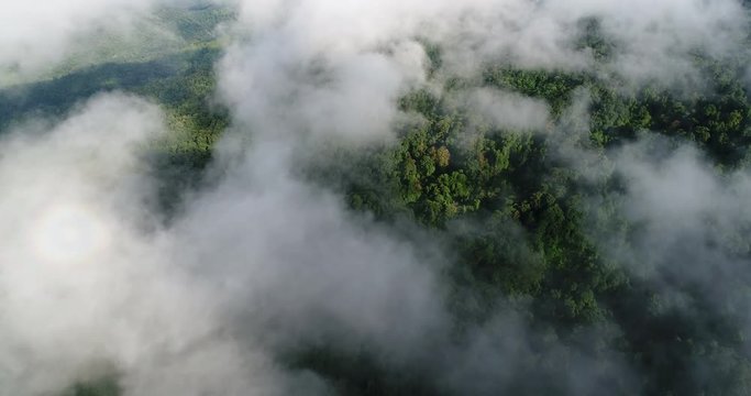Aerial View. Flying over the beautiful mountain in clouds.