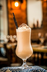 three cocktails in plastic cups with straws