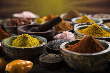 Spices and herbs in wooden bowls. Food and cuisine ingredients