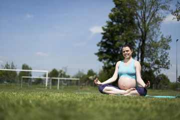 Fototapeta premium Yoga, Pregnant women doing relaxation exercise