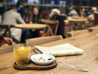 Cafe, on the table a cup of tea and a newspaper.
