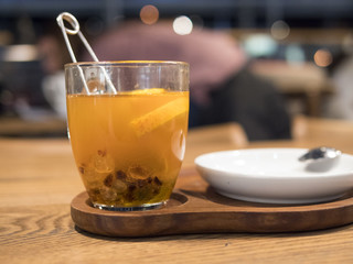 Tea in a transparent cup with orange slices