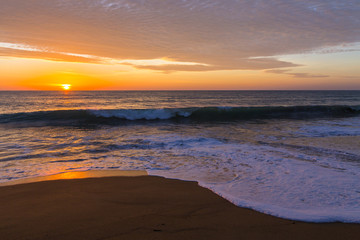 Sand dunes against the sunset light on the beach