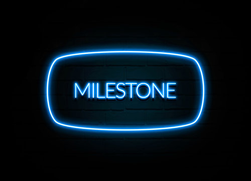 Milestone  - colorful Neon Sign on brickwall