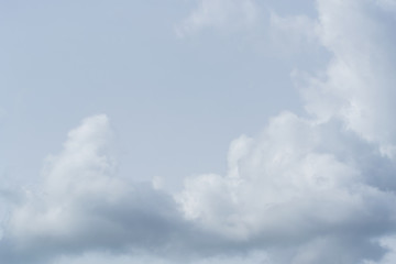 After heavy rain, clusters of white clouds gather in various shapes in the air.