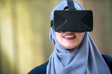 Hijab woman wearing vr (virtual reality) box. Education concept.
