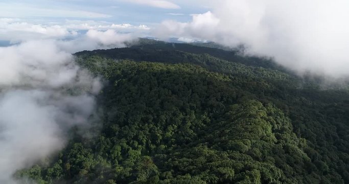 Aerial View. Flying over the beautiful mountain in clouds.