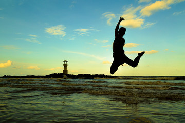 silhouette man jump on beach