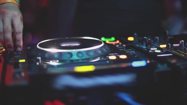 Close up of DJ plays music mixing and scratching on turntable music equipment. 1920x1080