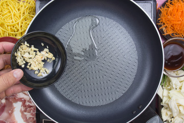 Chef putting minced garlic for cooking Yakisoba
