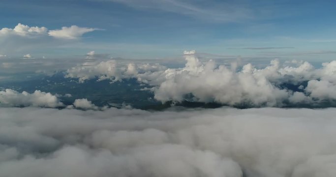 Aerial View. Flying over the beautiful mountain in clouds.