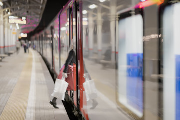 Railway subway station, at night, passenger train stopped. Unrecognizable girl enters train....