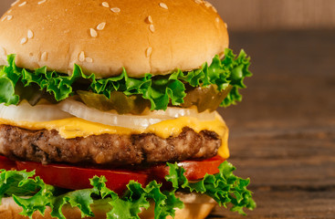 Bright juicy appetizing burgers with a cutlet, cheese, marinated cucumbers,