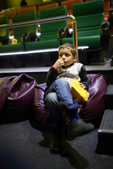 Boy with popcorn in cinema