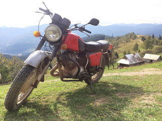 Old Soviet Motorcycle on the background of Carpathian mountains
