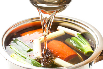 pour broth transparent to the broth pot on white background