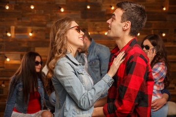 Fototapeta premium Acquaintance and flirtation. A woman and a group of men. Friends discuss the girl