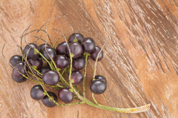 Jaboticaba (brazilian berry) on wooden table (Plinia cauliflora)