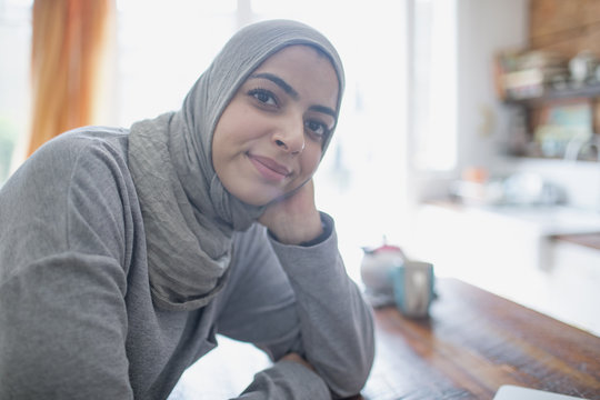 Muslim businesswoman wearing a hijab in her kitchen