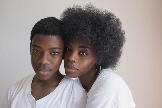 Portrait of teenage boy with his mother standing 