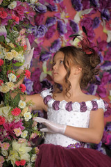 Girl in a purple dress on a floral background