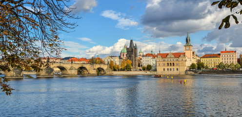 Obraz premium Prague, Czech Republic - October 8, 2017: Beautiful autumn view on Vltava river, Charles Bridge and Old Town of Prague, Czech Republic. Prague city center and dramatic skyline 