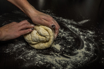 Female hands knead dough from flour for baking in the kitchen, handmade